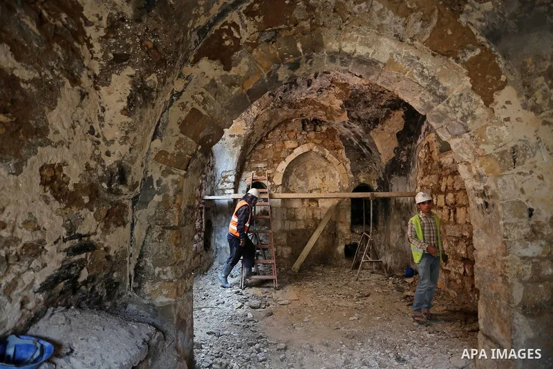 A Palestinian worker renovates the archaeological Maqam Al-Khader, in Deir al-Balah, central Gaza on March 24, 2016. Maqam Al-Kader is one of the monuments of the city of Deir al-Balah, the Ministry of Tourism and Antiqu...