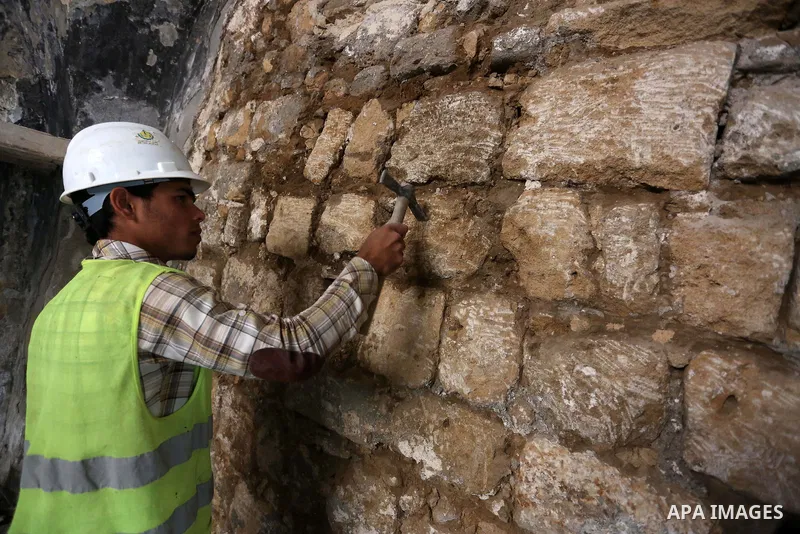 A Palestinian worker renovates the archaeological Maqam Al-Khader, in Deir al-Balah, central Gaza on March 24, 2016. Maqam Al-Kader is one of the monuments of the city of Deir al-Balah, the Ministry of Tourism and Antiqu...