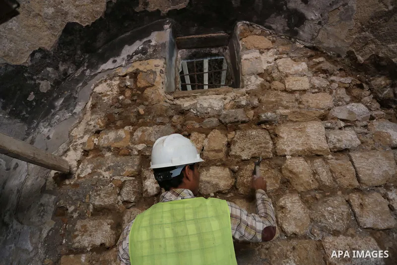 A Palestinian worker renovates the archaeological Maqam Al-Khader, in Deir al-Balah, central Gaza on March 24, 2016. Maqam Al-Kader is one of the monuments of the city of Deir al-Balah, the Ministry of Tourism and Antiqu...