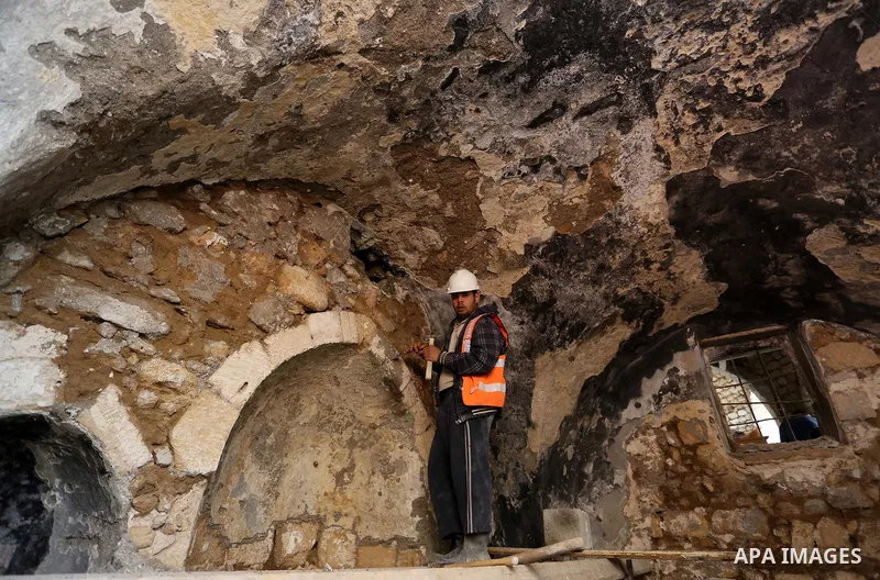 A Palestinian worker renovates the archaeological Maqam Al-Khader, in Deir al-Balah, central Gaza on March 24, 2016. Maqam Al-Kader is one of the monuments of the city of Deir al-Balah, the Ministry of Tourism and Antiqu...