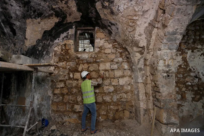 A Palestinian worker renovates the archaeological Maqam Al-Khader, in Deir al-Balah, central Gaza on March 24, 2016. Maqam Al-Kader is one of the monuments of the city of Deir al-Balah, the Ministry of Tourism and Antiqu...