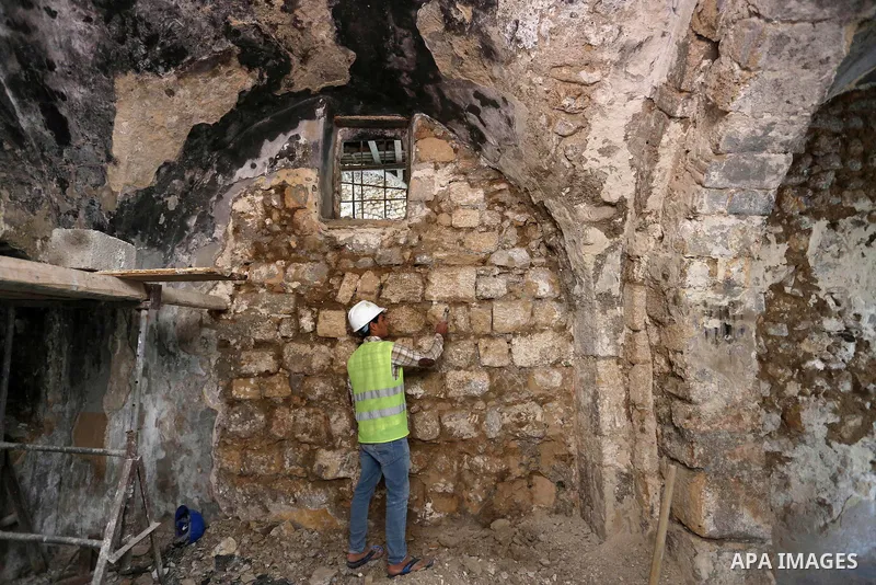 A Palestinian worker renovates the archaeological Maqam Al-Khader, in Deir al-Balah, central Gaza on March 24, 2016. Maqam Al-Kader is one of the monuments of the city of Deir al-Balah, the Ministry of Tourism and Antiqu...