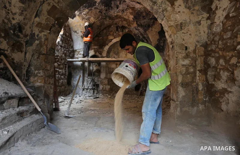 A Palestinian worker renovates the archaeological Maqam Al-Khader, in Deir al-Balah, central Gaza on March 24, 2016. Maqam Al-Kader is one of the monuments of the city of Deir al-Balah, the Ministry of Tourism and Antiqu...