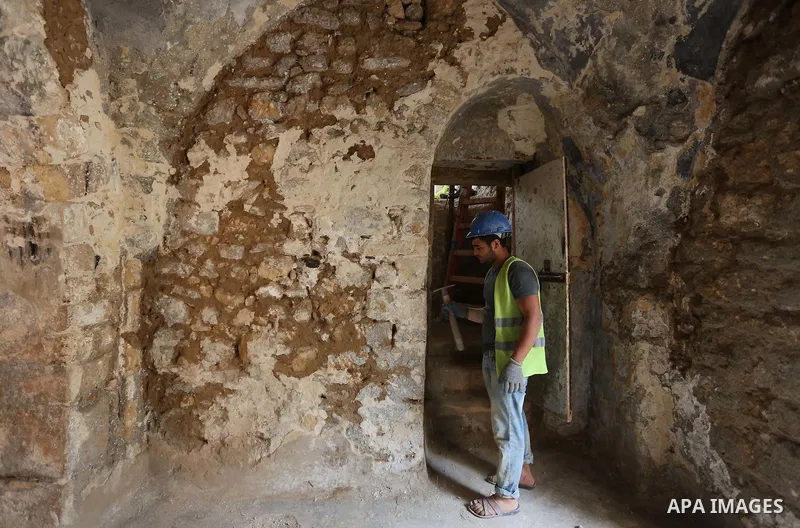 A Palestinian worker renovates the archaeological Maqam Al-Khader, in Deir al-Balah, central Gaza on March 24, 2016. Maqam Al-Kader is one of the monuments of the city of Deir al-Balah, the Ministry of Tourism and Antiqu...