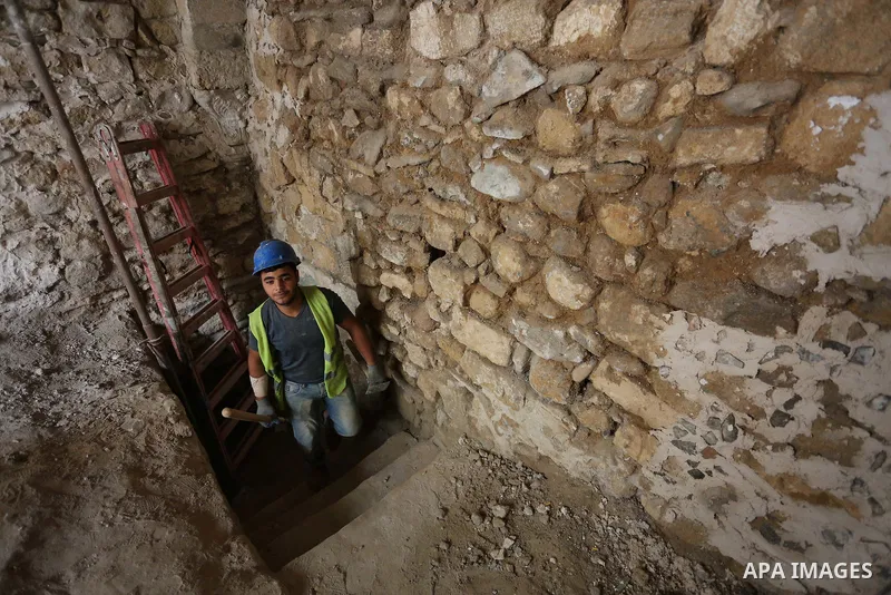 A Palestinian worker renovates the archaeological Maqam Al-Khader, in Deir al-Balah, central Gaza on March 24, 2016. Maqam Al-Kader is one of the monuments of the city of Deir al-Balah, the Ministry of Tourism and Antiqu...