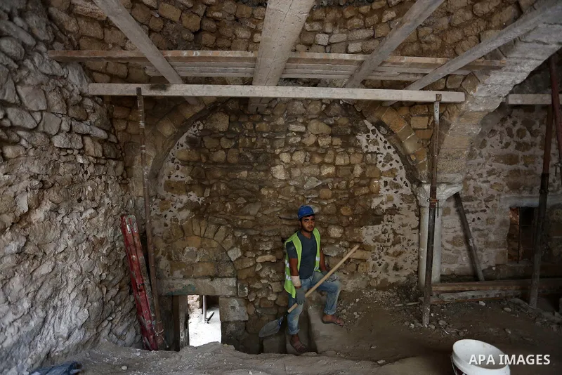 A Palestinian worker renovates the archaeological Maqam Al-Khader, in Deir al-Balah, central Gaza on March 24, 2016. Maqam Al-Kader is one of the monuments of the city of Deir al-Balah, the Ministry of Tourism and Antiqu...