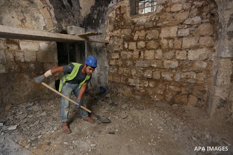 A Palestinian worker renovates the archaeological Maqam Al-Khader, in Deir al-Balah, central Gaza on March 24, 2016. Maqam Al-Kader is one of the monuments of the city of Deir al-Balah, the Ministry of Tourism and Antiqu...