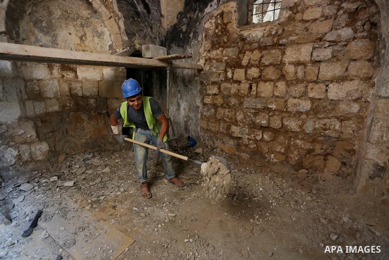 A Palestinian worker renovates the archaeological Maqam Al-Khader, in Deir al-Balah, central Gaza on March 24, 2016. Maqam Al-Kader is one of the monuments of the city of Deir al-Balah, the Ministry of Tourism and Antiqu...