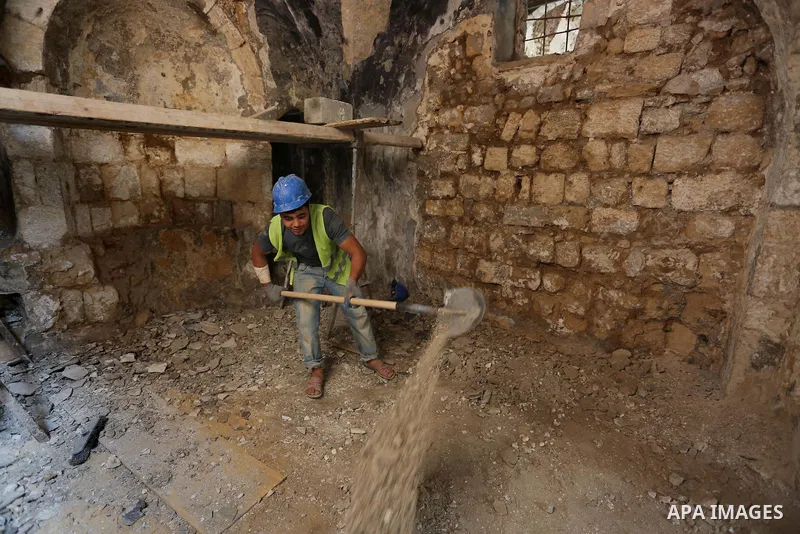 A Palestinian worker renovates the archaeological Maqam Al-Khader, in Deir al-Balah, central Gaza on March 24, 2016. Maqam Al-Kader is one of the monuments of the city of Deir al-Balah, the Ministry of Tourism and Antiqu...