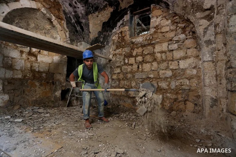 A Palestinian worker renovates the archaeological Maqam Al-Khader, in Deir al-Balah, central Gaza on March 24, 2016. Maqam Al-Kader is one of the monuments of the city of Deir al-Balah, the Ministry of Tourism and Antiqu...