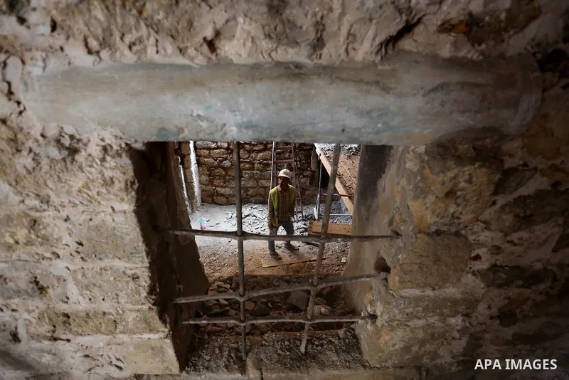 A Palestinian worker renovates the archaeological Maqam Al-Khader, in Deir al-Balah, central Gaza on March 24, 2016. Maqam Al-Kader is one of the monuments of the city of Deir al-Balah, the Ministry of Tourism and Antiqu...