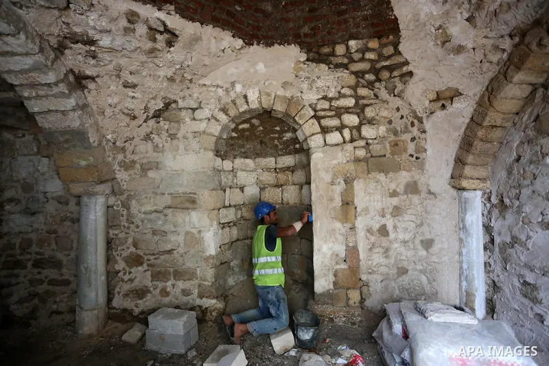 A Palestinian worker renovates the archaeological Maqam Al-Khader, in Deir al-Balah, central Gaza on March 24, 2016. Maqam Al-Kader is one of the monuments of the city of Deir al-Balah, the Ministry of Tourism and Antiqu...