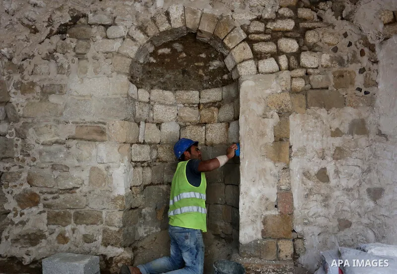 A Palestinian worker renovates the archaeological Maqam Al-Khader, in Deir al-Balah, central Gaza on March 24, 2016. Maqam Al-Kader is one of the monuments of the city of Deir al-Balah, the Ministry of Tourism and Antiqu...