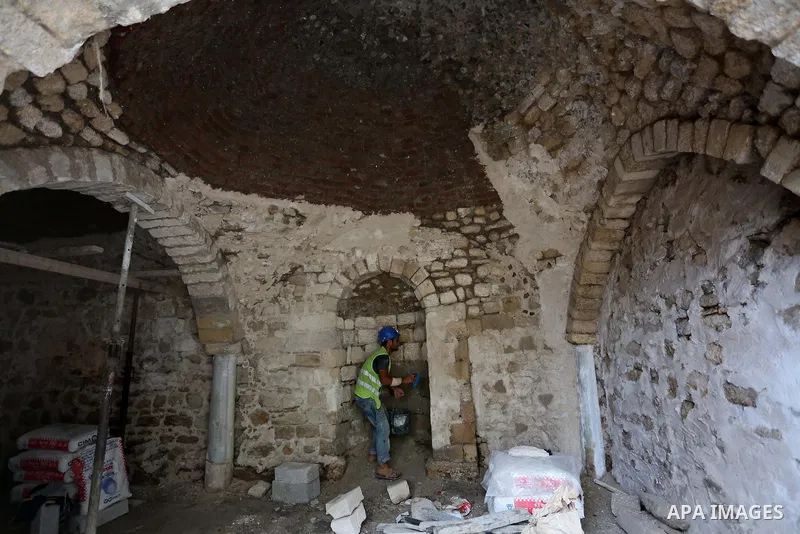 A Palestinian worker renovates the archaeological Maqam Al-Khader, in Deir al-Balah, central Gaza on March 24, 2016. Maqam Al-Kader is one of the monuments of the city of Deir al-Balah, the Ministry of Tourism and Antiqu...