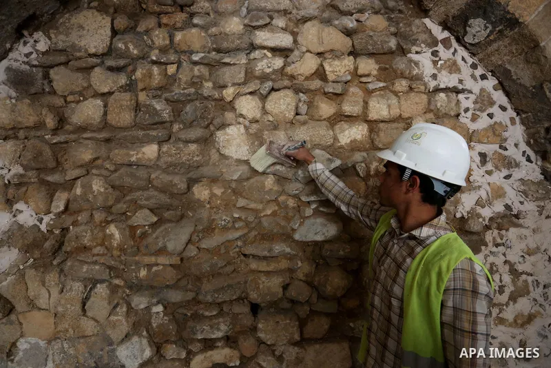 A Palestinian worker renovates the archaeological Maqam Al-Khader, in Deir al-Balah, central Gaza on March 24, 2016. Maqam Al-Kader is one of the monuments of the city of Deir al-Balah, the Ministry of Tourism and Antiqu...