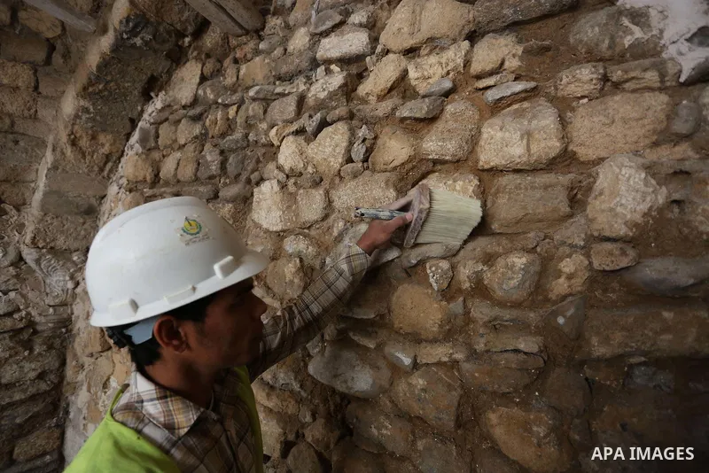 A Palestinian worker renovates the archaeological Maqam Al-Khader, in Deir al-Balah, central Gaza on March 24, 2016. Maqam Al-Kader is one of the monuments of the city of Deir al-Balah, the Ministry of Tourism and Antiqu...