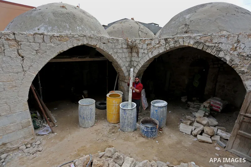 A Palestinian worker renovates the archaeological Maqam Al-Khader, in Deir al-Balah, central Gaza on March 24, 2016. Maqam Al-Kader is one of the monuments of the city of Deir al-Balah, the Ministry of Tourism and Antiqu...