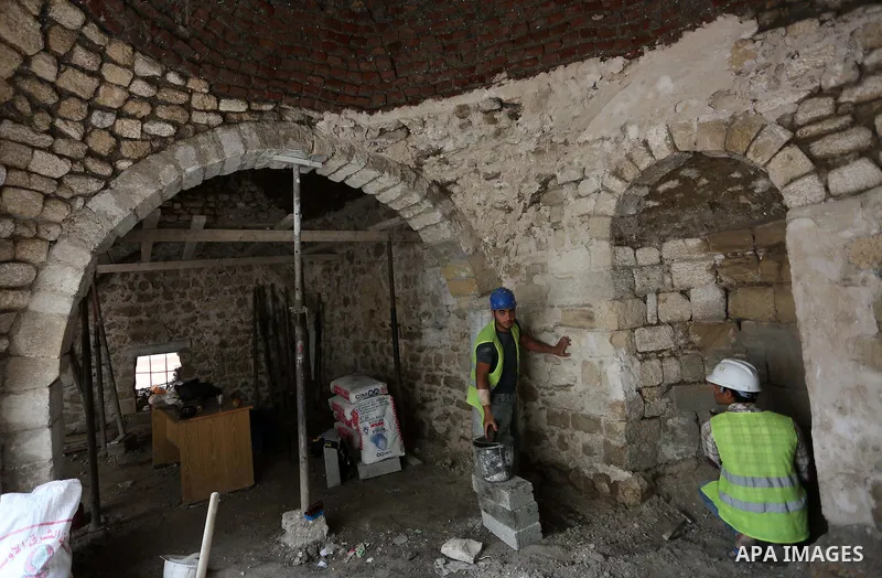 Palestinian workers renovate the archaeological Maqam Al-Khader, in Deir al-Balah, central Gaza on March 24, 2016. Maqam Al-Kader is one of the monuments of the city of Deir al-Balah, the Ministry of Tourism and Antiquit...