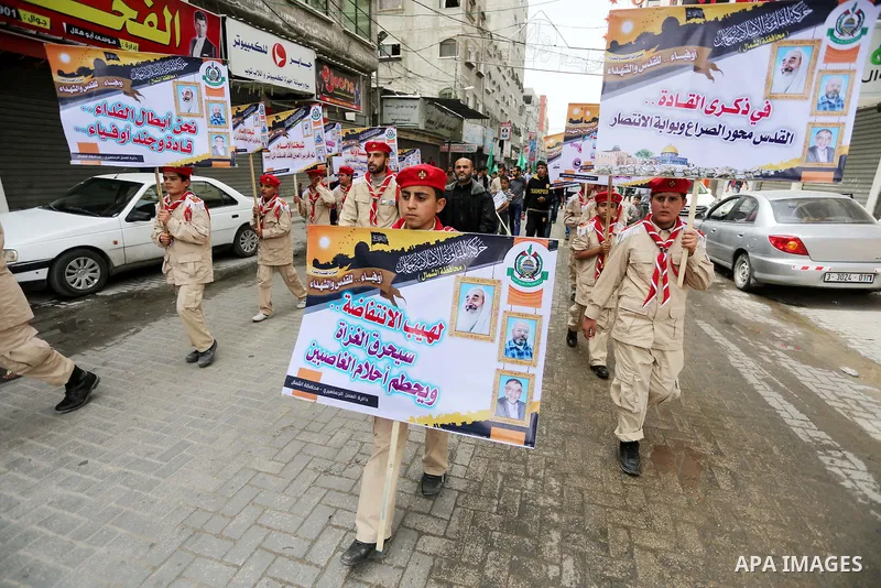 Palestinian supporters of Hamas movement take part during a rally to mark the 12th anniversary of the death of assassinated Hamas spiritual leader Sheikh Ahmed Yassine and show solidarity with Palestinians in Jerusalem a...
