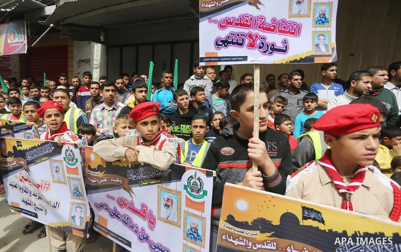 Palestinian supporters of Hamas movement take part during a rally to mark the 12th anniversary of the death of assassinated Hamas spiritual leader Sheikh Ahmed Yassine and show solidarity with Palestinians in Jerusalem a...