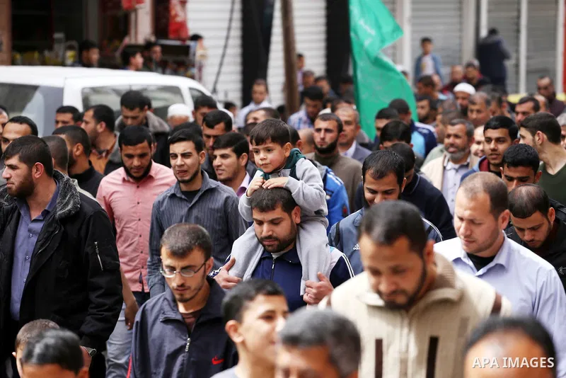 Palestinian supporters of Hamas movement take part during a rally to mark the 12th anniversary of the death of assassinated Hamas spiritual leader Sheikh Ahmed Yassine and show solidarity with Palestinians in Jerusalem a...