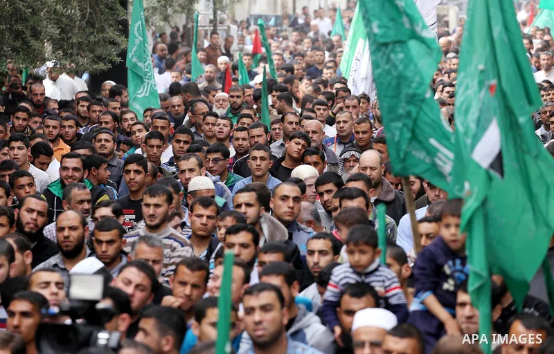 Palestinian supporters of Hamas movement take part during a rally to mark the 12th anniversary of the death of assassinated Hamas spiritual leader Sheikh Ahmed Yassine and show solidarity with Palestinians in Jerusalem a...
