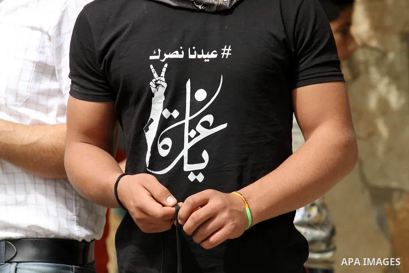 A Palestinian protester prepares his a slingshot during clashes with Israeli security forces following a demonstration against the expropriation of Palestinian land by Israel in the village of Kfar Qaddum, near Nablus, i...