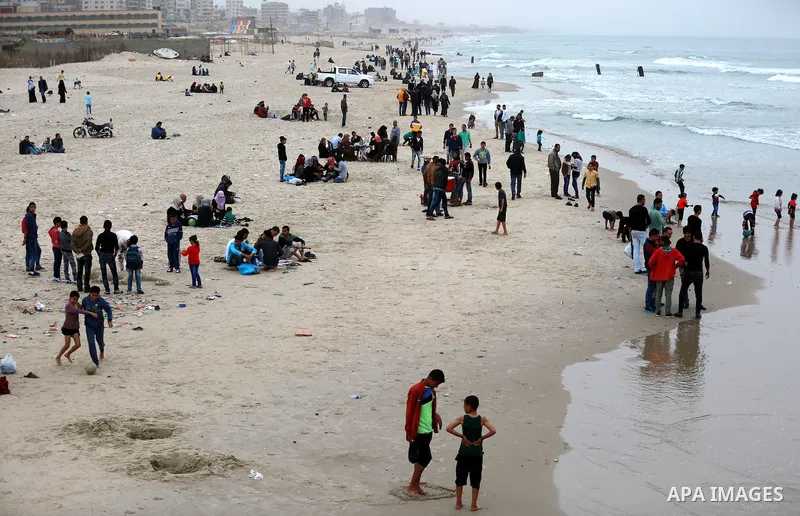 Palestinians enjoy a day at the beach of the Mediterranean sea on the coast of Gaza city, on March 25, 2016. Photo by Yasser Qudih