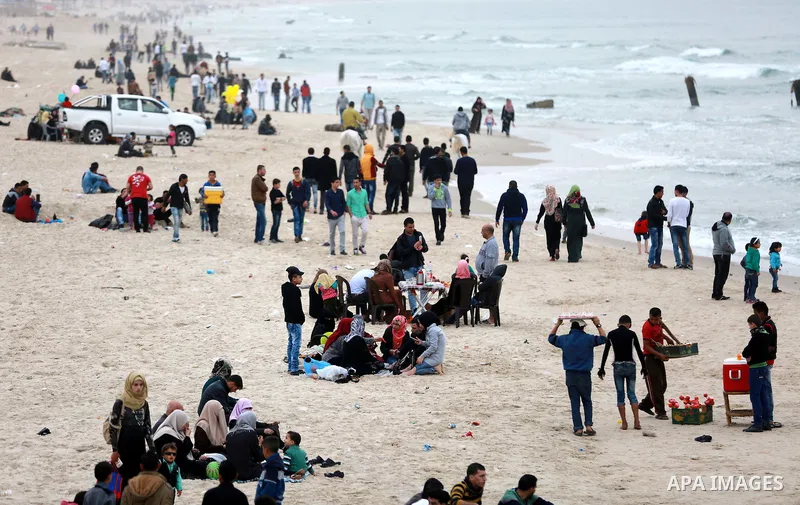 Palestinians enjoy a day at the beach of the Mediterranean sea on the coast of Gaza city, on March 25, 2016. Photo by Yasser Qudih