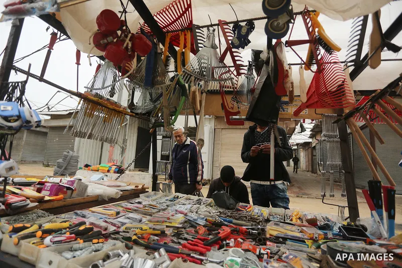 Palestinian vendors display all kinds of used goods at El-Yarmouk market in Gaza city, on March 26, 2016. Photo by Mohammed Asad