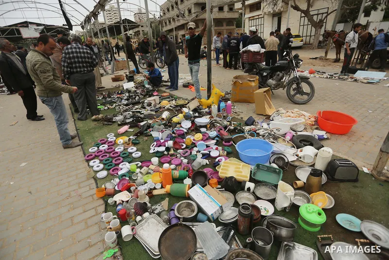 Palestinian vendors display all kinds of used goods at El-Yarmouk market in Gaza city, on March 26, 2016. Photo by Mohammed Asad