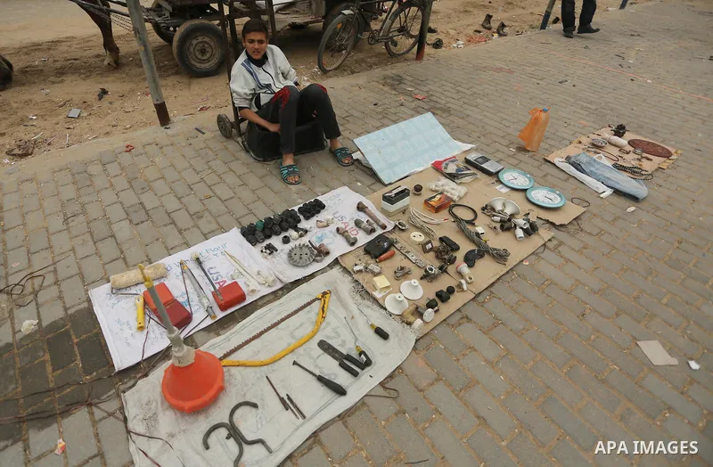 Palestinian vendors display all kinds of used goods at El-Yarmouk market in Gaza city, on March 26, 2016. Photo by Mohammed Asad