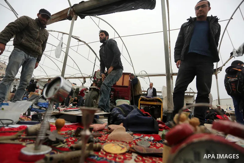 Palestinian vendors display all kinds of used goods at El-Yarmouk market in Gaza city, on March 26, 2016. Photo by Mohammed Asad