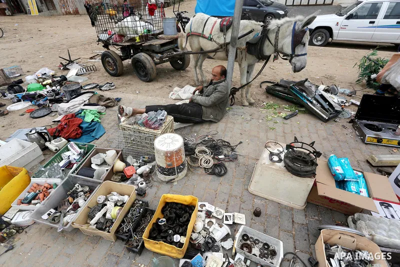 Palestinian vendors display all kinds of used goods at El-Yarmouk market in Gaza city, on March 26, 2016. Photo by Mohammed Asad