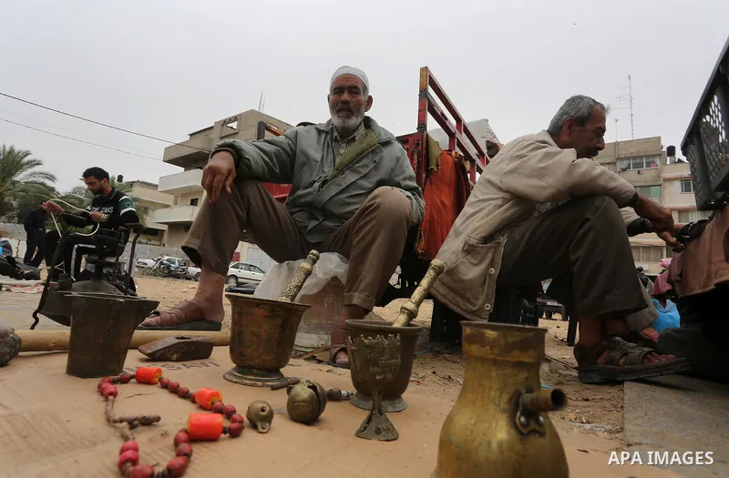 Palestinian vendors display all kinds of used goods at El-Yarmouk market in Gaza city, on March 26, 2016. Photo by Mohammed Asad