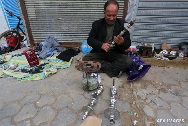 Palestinian vendors display all kinds of used goods at El-Yarmouk market in Gaza city, on March 26, 2016. Photo by Mohammed Asad