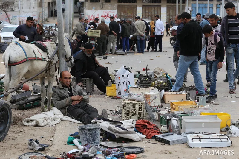 Palestinian vendors display all kinds of used goods at El-Yarmouk market in Gaza city, on March 26, 2016. Photo by Mohammed Asad