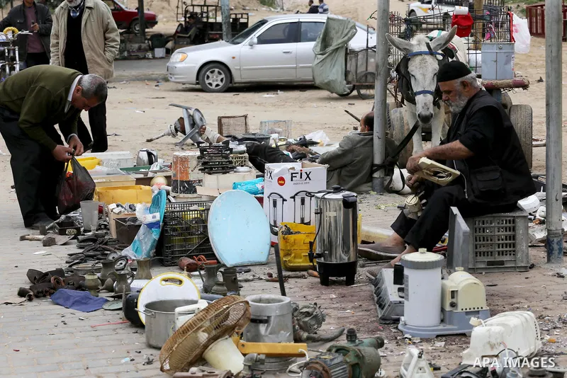 Palestinian vendors display all kinds of used goods at El-Yarmouk market in Gaza city, on March 26, 2016. Photo by Mohammed Asad
