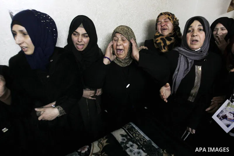 Relatives mourn next the body of Ramzi al-Qasrawi, 21, a Palestinian man who was killed in a reported stabbing attack, during his funeral in the West Bank town of Hebron on March 26, 2016. Ramzi al-Qasrawi was killed on...