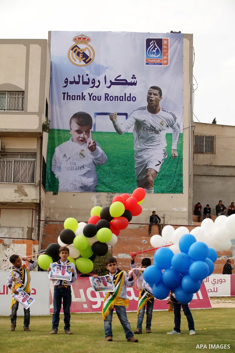 Palestinian chlidren hold ballons and posters bearing a portrait of Palestinian boy Ahmed Dawabsha, 5, who suffered severe burns in an arson attack by suspected Jewish attackers on his family home last July and in which...