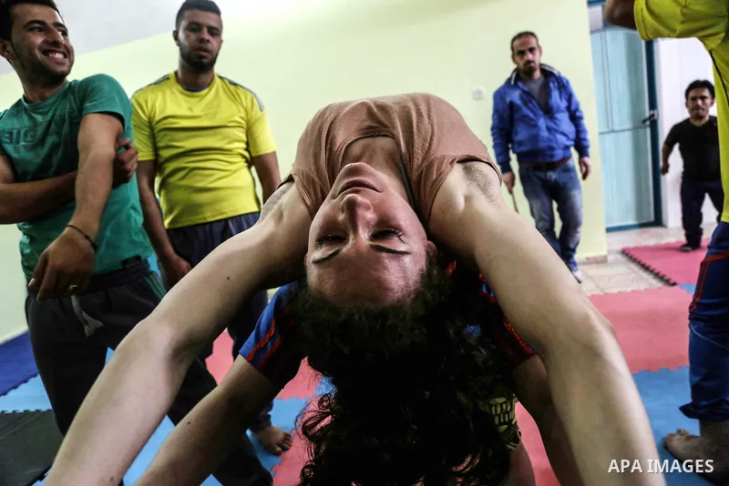 An Italian delegation train Palestinian youths at a Palestinian Circus School in Beit Lahiya in the north of the Gaza strip on March 27, 2016. Photo by Nidal Alwaheidi