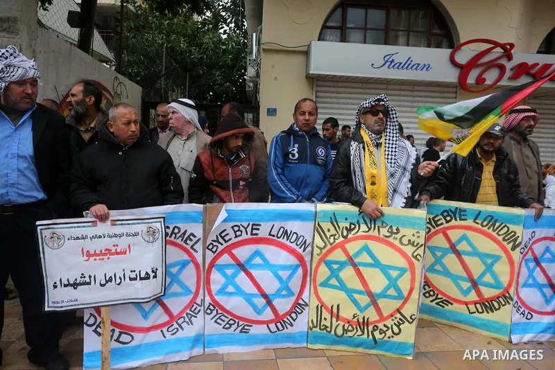 Palestinian families of martyrs, hold banners during a protest to demand their salaries, in front of Red cross office, in Gaza city, on March 28, 2016. Photo by Mohammed Asad