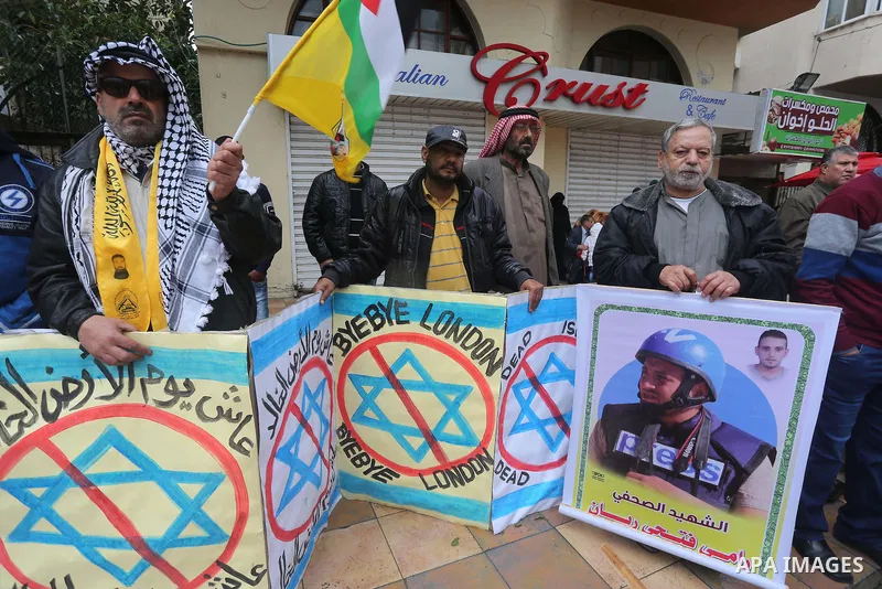 Palestinian families of martyrs, hold banners during a protest to demand their salaries, in front of Red cross office, in Gaza city, on March 28, 2016. Photo by Mohammed Asad
