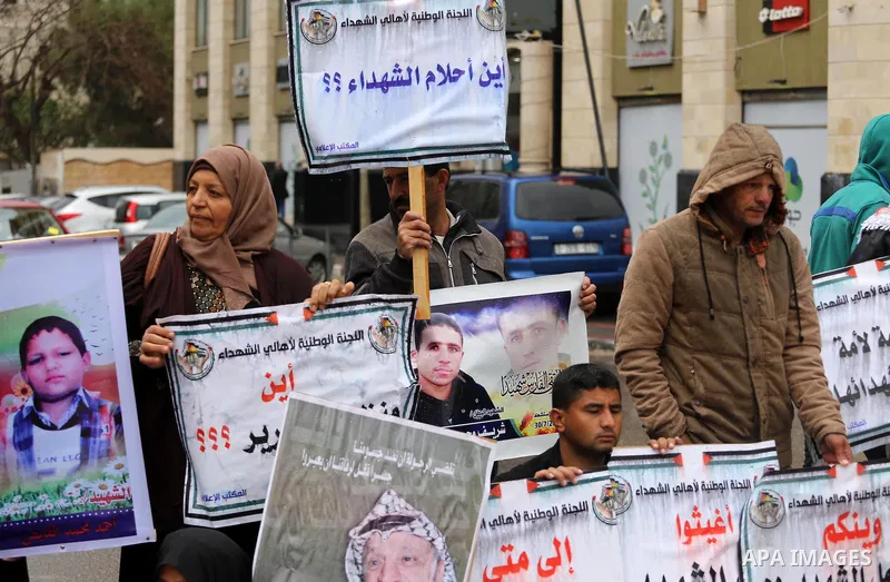 Palestinian families of martyrs, hold banners during a protest to demand their salaries, in front of Red cross office, in Gaza city, on March 28, 2016. Photo by Mohammed Asad