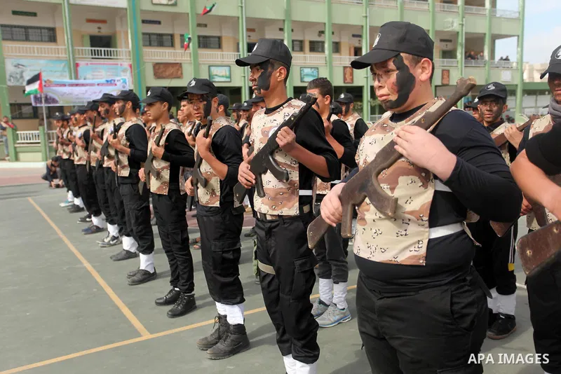 Palestinian students demonstrate their skills during a military-style show at a school in Rafah in the southern Gaza Strip March 28, 2016. Photo by Ashraf Amra