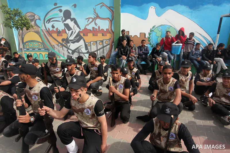Palestinian students demonstrate their skills during a military-style show at a school in Rafah in the southern Gaza Strip March 28, 2016. Photo by Ashraf Amra