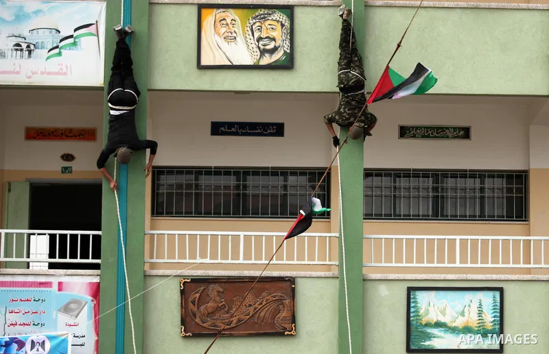 Palestinian students demonstrate their skills during a military-style show at a school in Rafah in the southern Gaza Strip March 28, 2016. Photo by Ashraf Amra