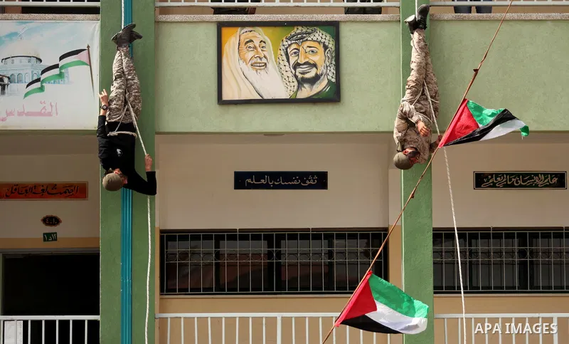 Palestinian students demonstrate their skills during a military-style show at a school in Rafah in the southern Gaza Strip March 28, 2016. Photo by Ashraf Amra