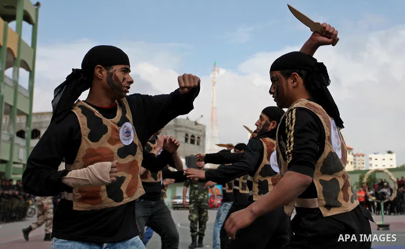 Palestinian students demonstrate their skills during a military-style show at a school in Rafah in the southern Gaza Strip March 28, 2016. Photo by Ashraf Amra