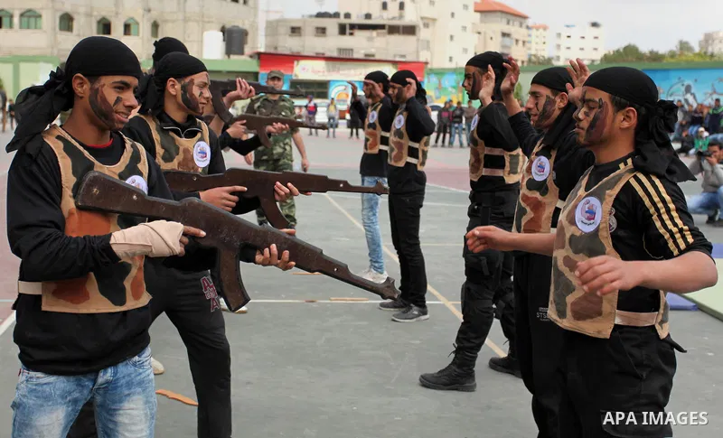 Palestinian students demonstrate their skills during a military-style show at a school in Rafah in the southern Gaza Strip March 28, 2016. Photo by Ashraf Amra